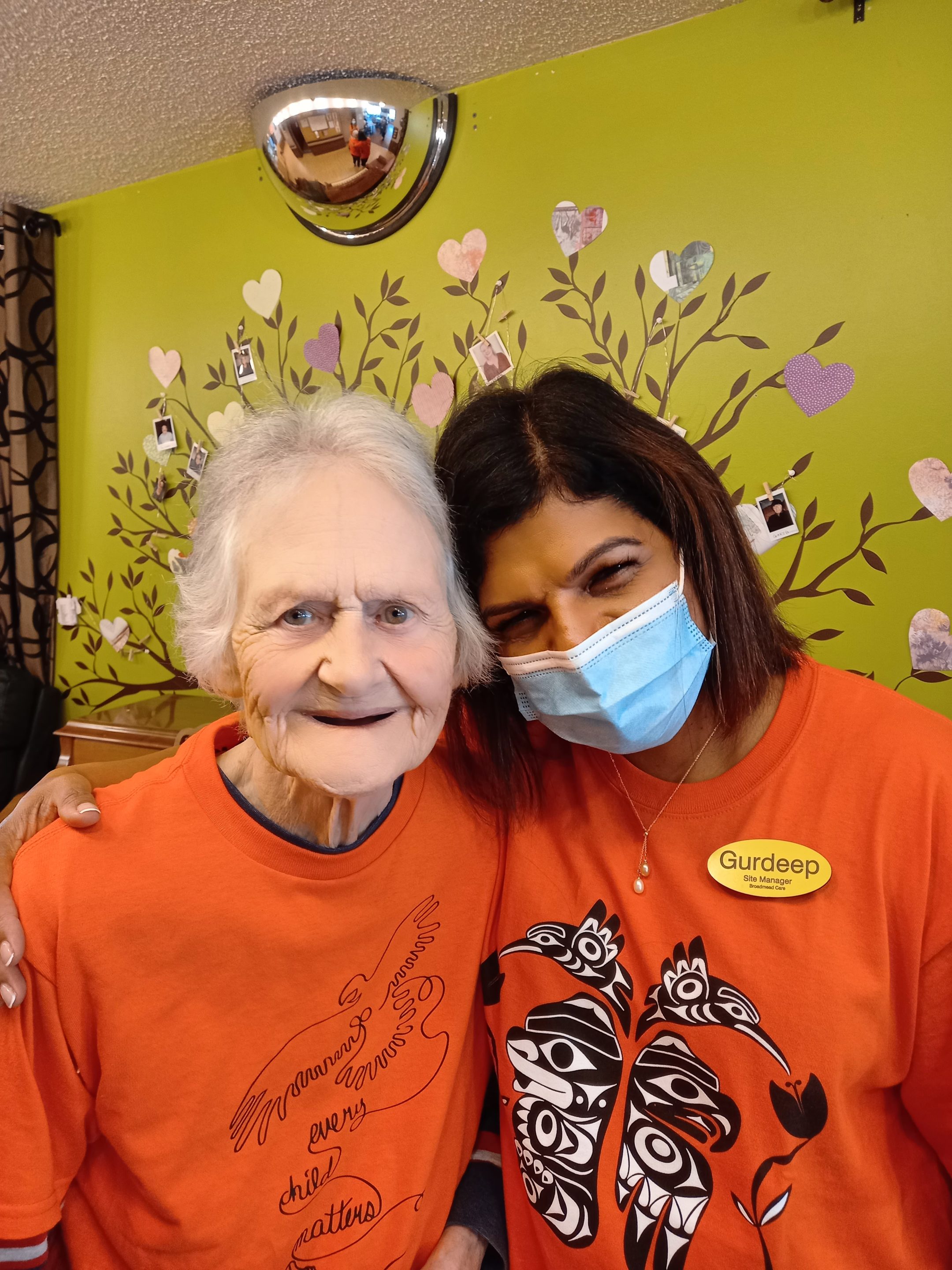 Orange Shirt Day at Broadmead Care at Rest Haven Lodge in Sidney. Care Manager Gurdeep (right) and a resident (left) are both wearing orange shirts.